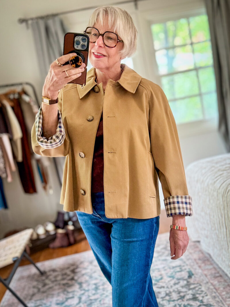 Susan B. takes a mirror selfie wearing a Sezane Bobby jacket and Paige Mason blue jeans.