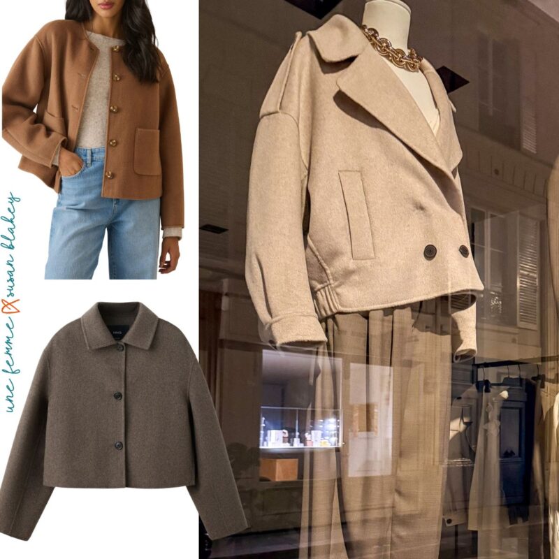 Two double-faced wool jackets, one in brown, one in dark taupe with a beige wool jacket in a shop window.