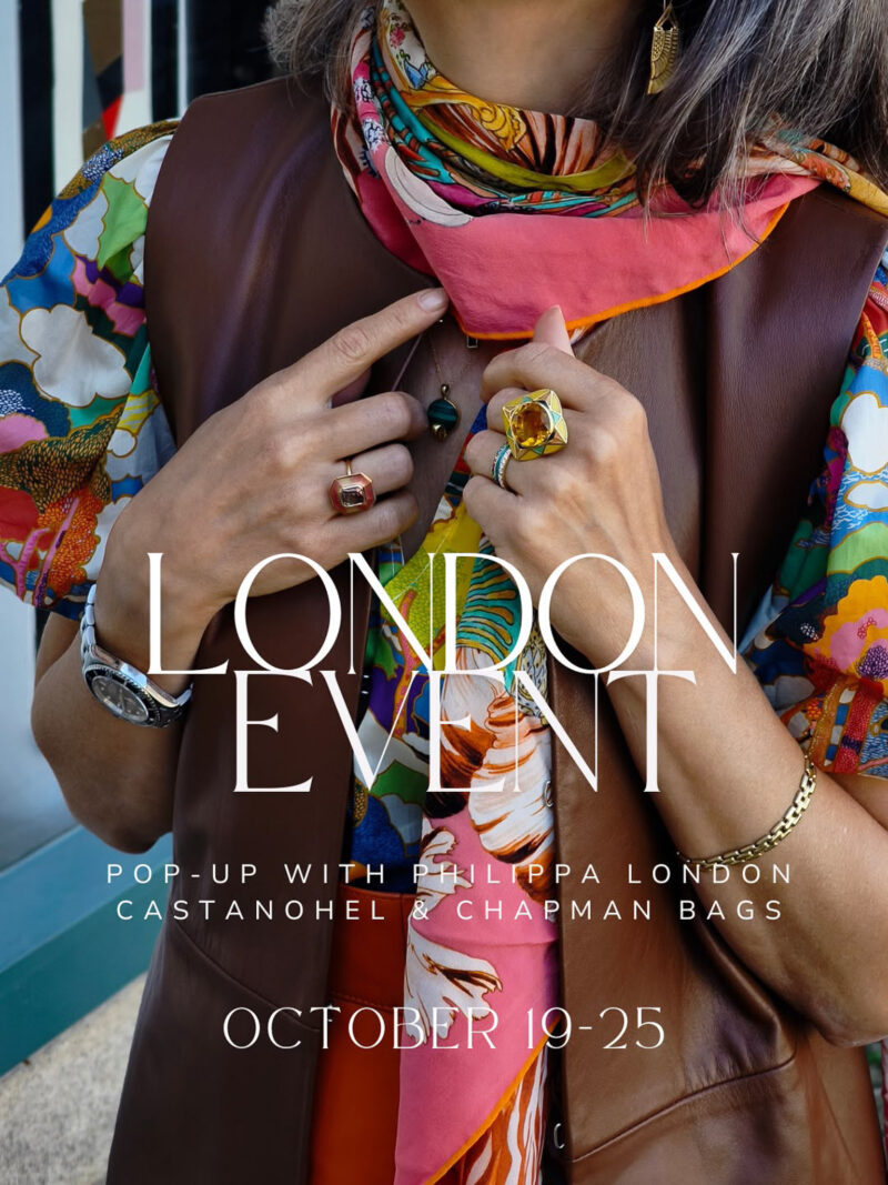 London pop-up event, October 19–25, with Philippa London, Castanohel and Chapman Bags. Close-up of colorful gemstone rings, a patterned scarf and a brown leather vest.